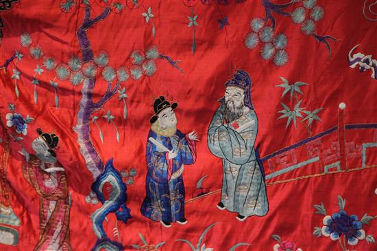 A Chinese embroidered silk red satin panel, early 20th century, approx. 66 x 410cm.